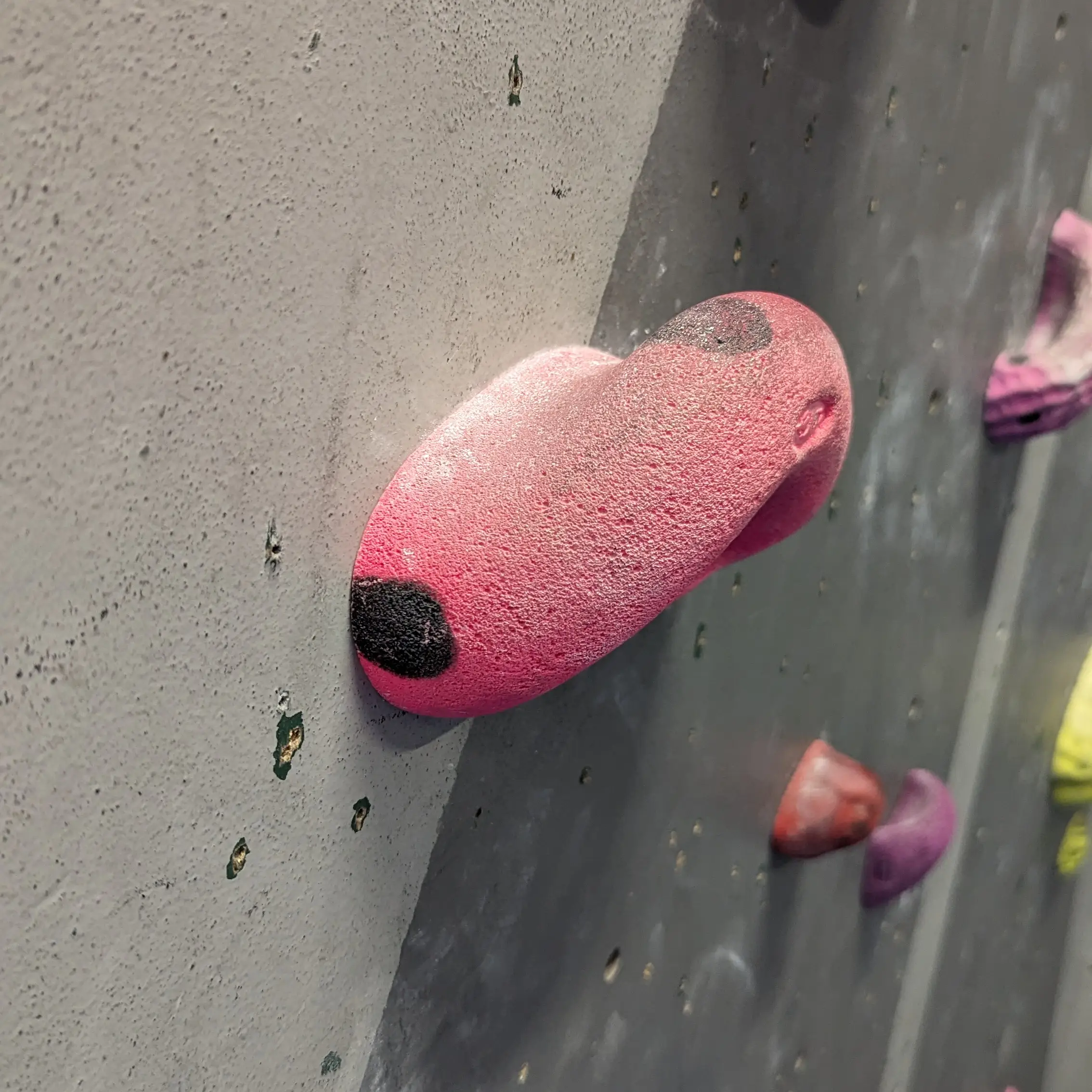 A pink jug hold that curves upwards.