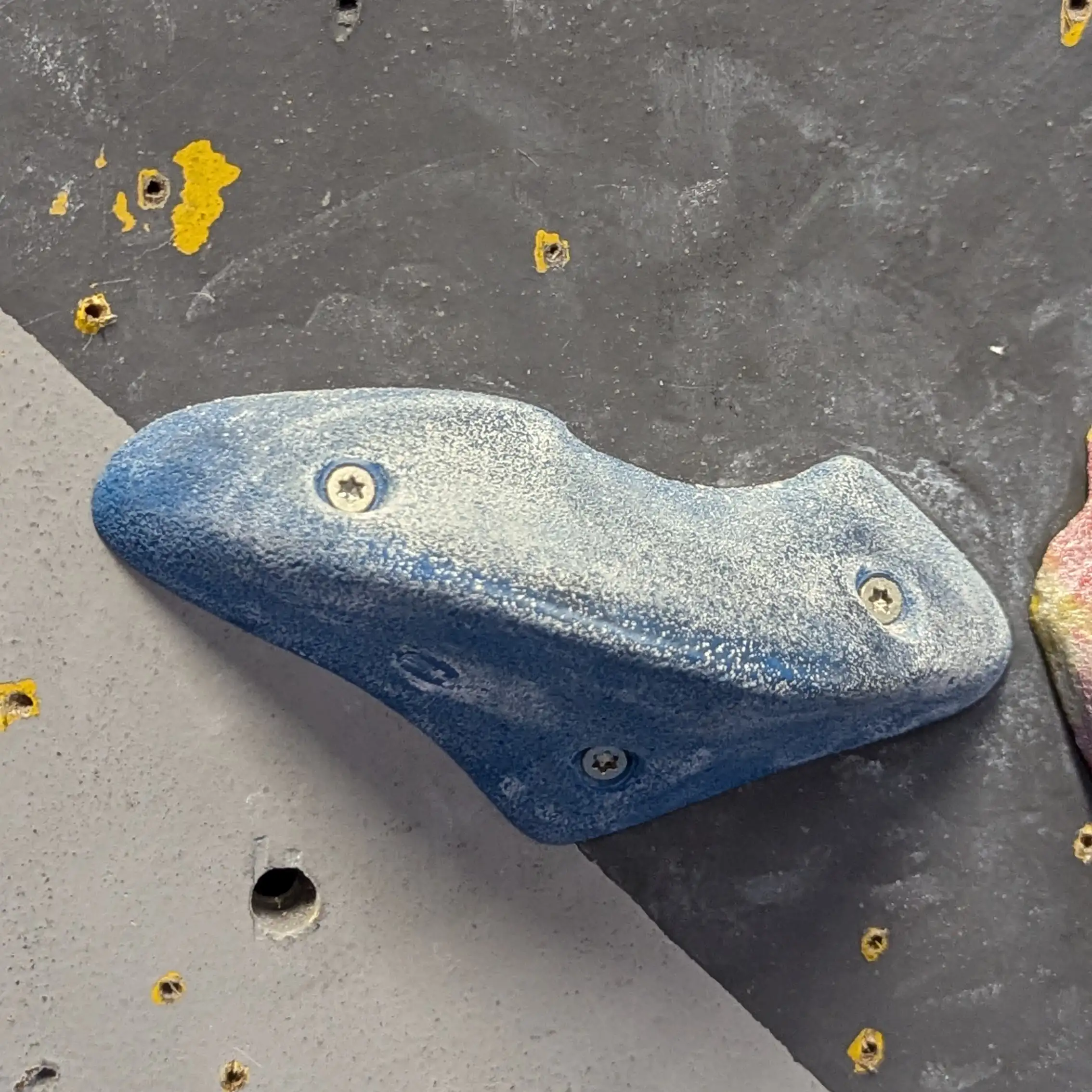 An up close picture of a small blue pinch hold.